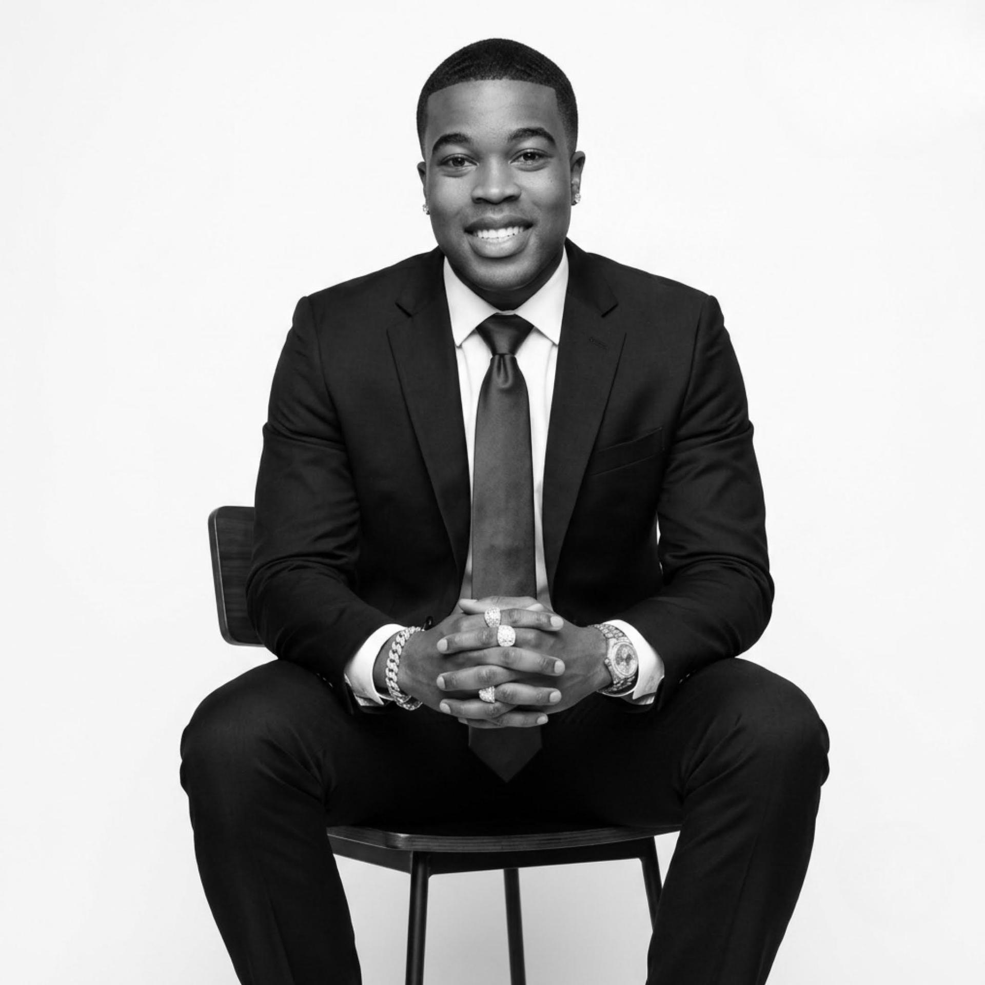 CEO of Investor Picks, seated in a tailored suit